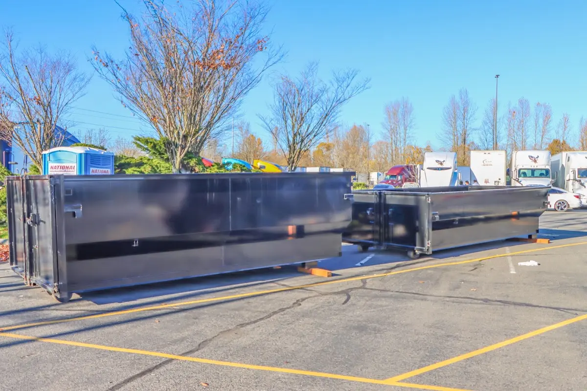 Professional dumpster rental service with roll-off container on residential driveway in Eagle Pass
